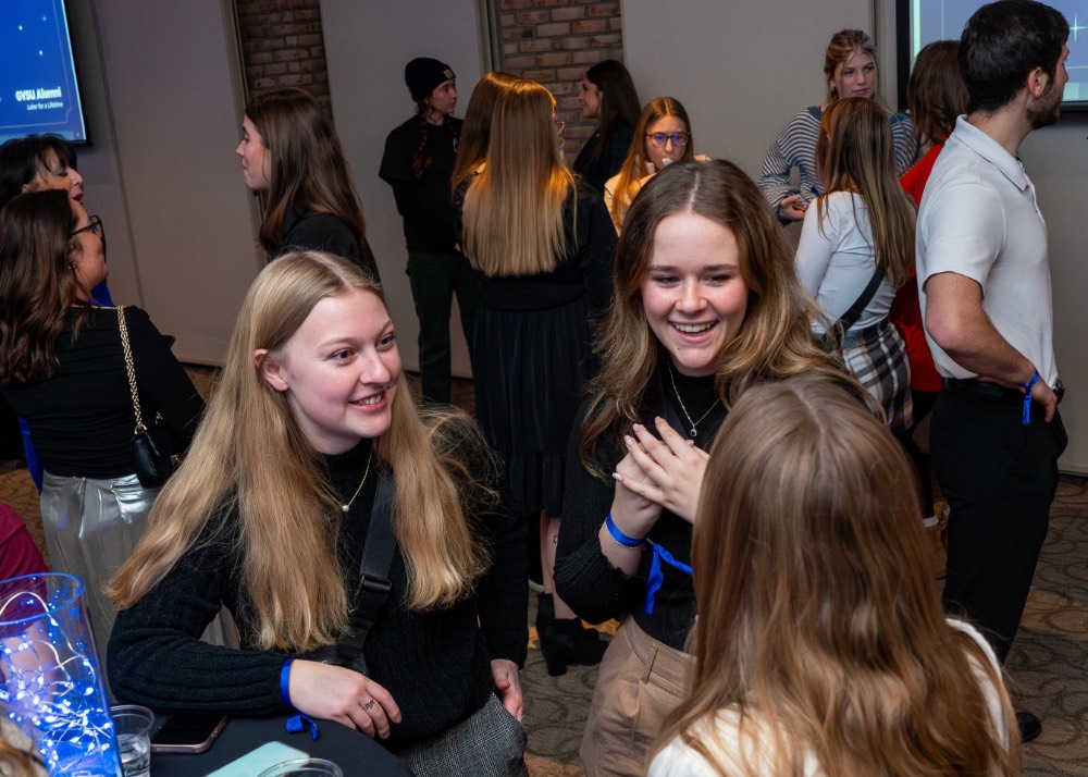 Group of three girls laugh and talk together